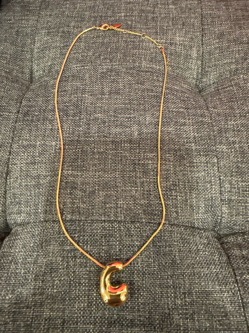 Polished Gold-Tone Pendant Necklace with Sculptural 'C' Accent